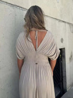 Plus size maxi dress with slit V-neck and smocked waist, trendy full-length dress by Trendsi, perfect for casual or special occasions.