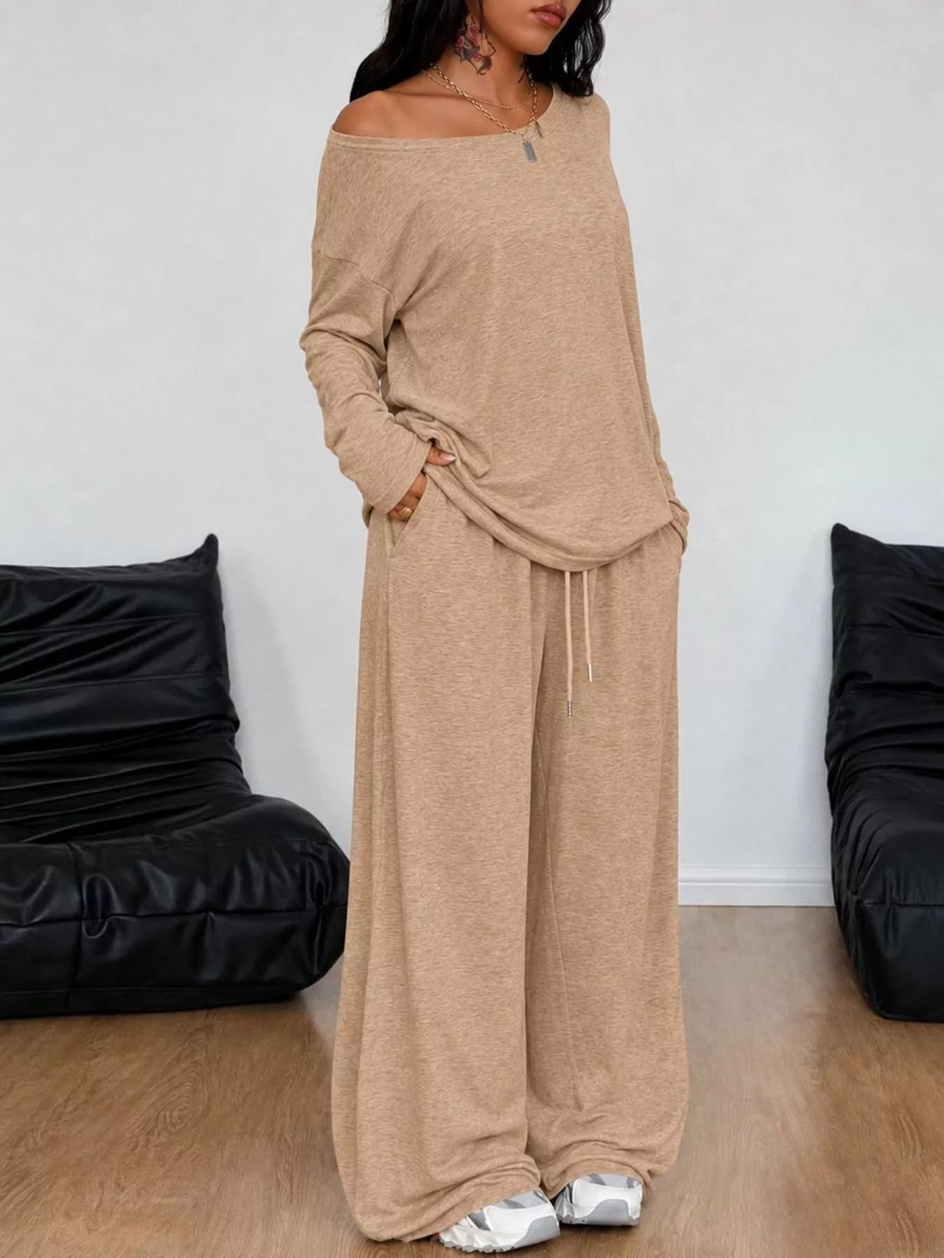Plus size loose fit one-shoulder T-shirt and pants set by Trendsi, featuring comfortable, casual style with relaxed fit.