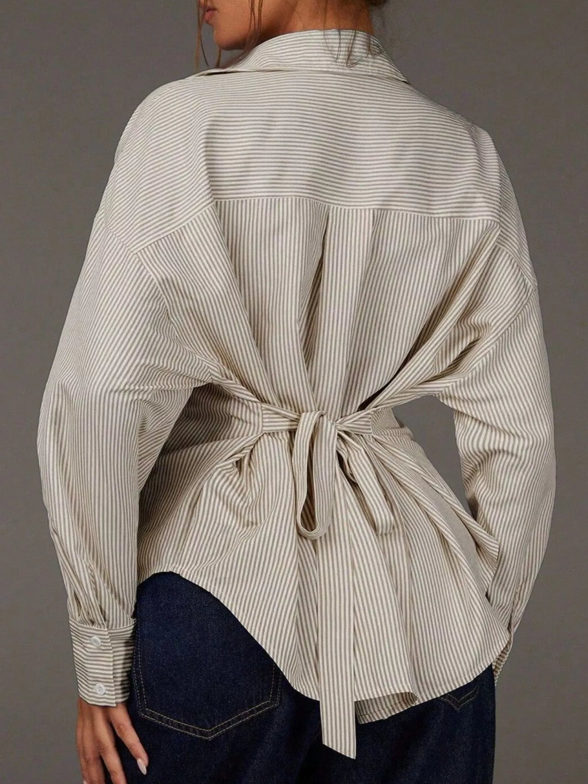 Casual striped button-down shirt by Trendsi, featuring a classic collar, long sleeves, and a relaxed fit in various colors.
