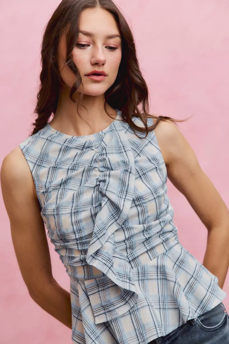 Plaid sleeveless ruffle peplum top from Plush Fashion Hub, featuring a checkered pattern and feminine ruffle details.