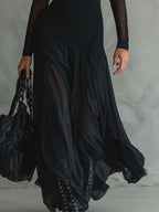 Elegant sheer mesh two-piece maxi dress set by Trendsi, featuring a flowing skirt and matching top with delicate see-through fabric.