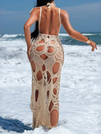 Cutout halter neck cover-up dress by Trendsi featuring a stylish design, open back, and flowy fabric perfect for beach or poolside wear.