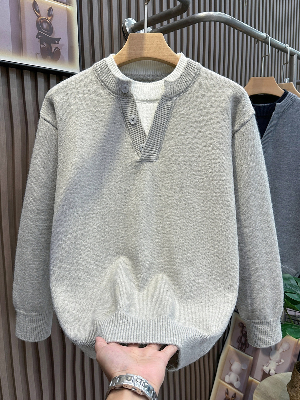 Beige knit pullover sweater, casual style, with a buttoned V-neck placket and a layered white inner collar.