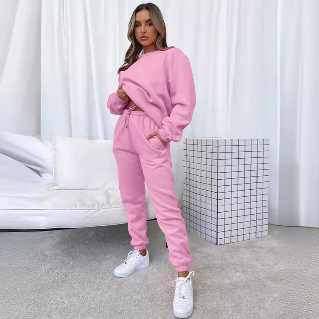 Women's solid color round neck pullover sweatshirt and pants set by Plush Fashion Hub, casualwear, front view showing relaxed fit.