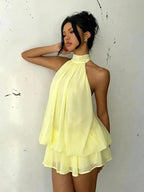 Women's chiffon halter mini dress by Plush Fashion Hub featuring a high-waist, open-back, and A-line silhouette.