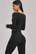 Fitglutes Activewear long sleeve crop top with fitted design, shown in black, suitable for gym, sports, and workout activities.