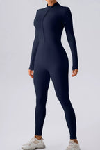 Trendsi half zip mock neck active jumpsuit in black, featuring long sleeves and fitted design for workout or casual wear.
