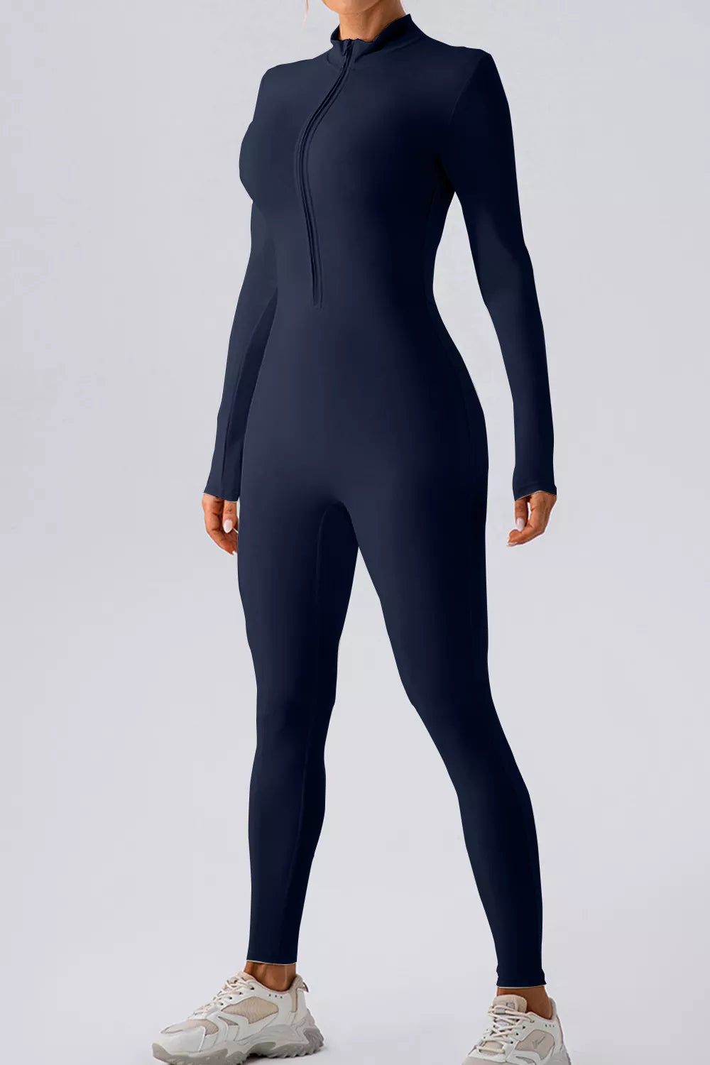 Trendsi half zip mock neck active jumpsuit in black, featuring long sleeves and fitted design for workout or casual wear.