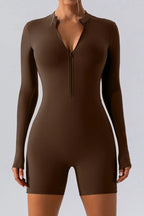Trendsi half zip long sleeve active romper in black, made for active wear, featuring a fitted design and sporty style.