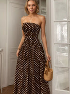 Polka dot strapless maxi dress by Shopimist featuring a flowing design and bold black and white pattern, perfect for summer wear.