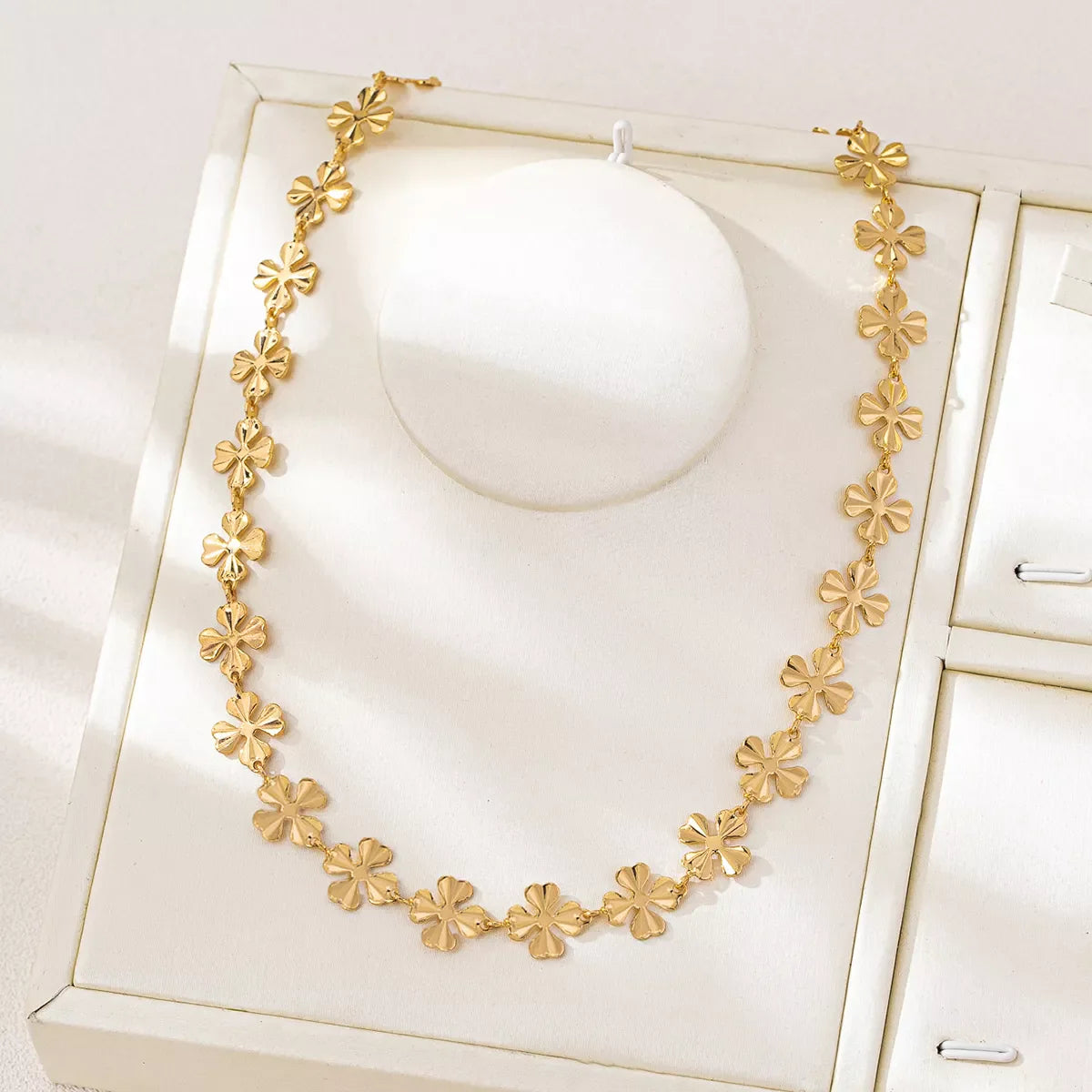 Gold-plated alloy flower chain necklace with delicate floral design, perfect for elegant jewelry accessories.
