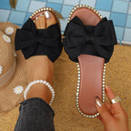 Plush Fashion Hub bowknot embellished flat sandals with open toes and ankle straps, featuring stylish bow accents.