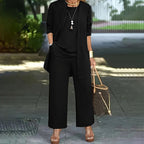 Plus size women's lounge set by FitiqueFit with cardigan, vest, and wide-leg pants, styled casually in a cozy indoor setting.