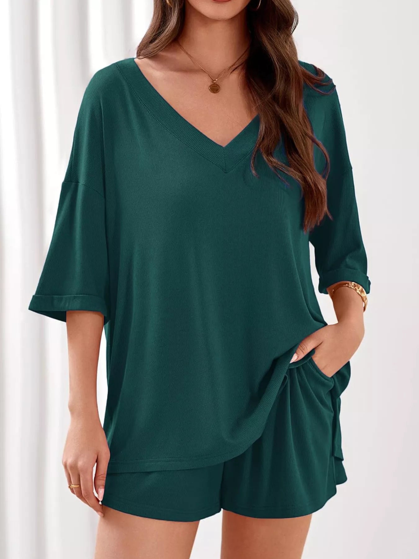Women's casual V-neck top and shorts set in solid color, trendy two-piece clothing outfit by Trendsi.