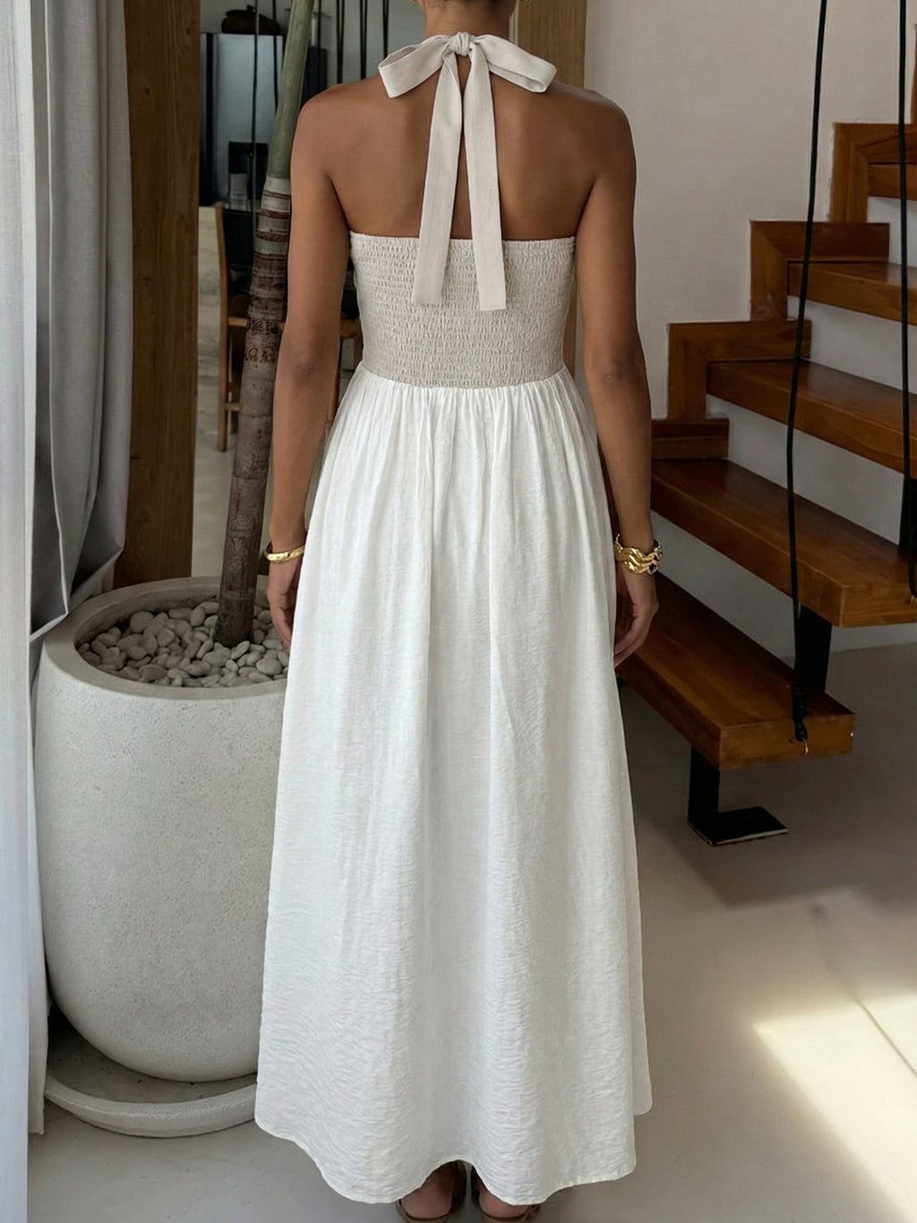 Elegant two-tone halter neck maxi dress with ruched details and pockets by Plush Fashion Hub, shown on a model.