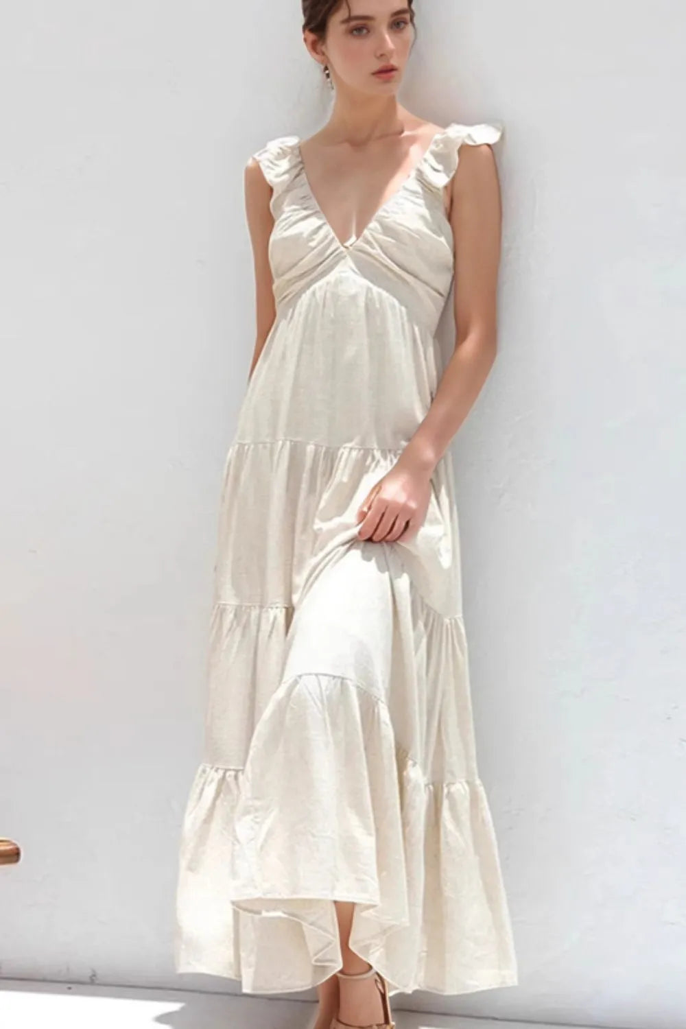 Women's 100% cotton ruffled V-neck tiered midi dress by Trendsi, featuring a flowy design with ruffles and a V-neck neckline.