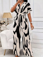 Abstract print wide-leg jumpsuit from Trendsi featuring a flowy design and stylish silhouette, shown in a full-length view.