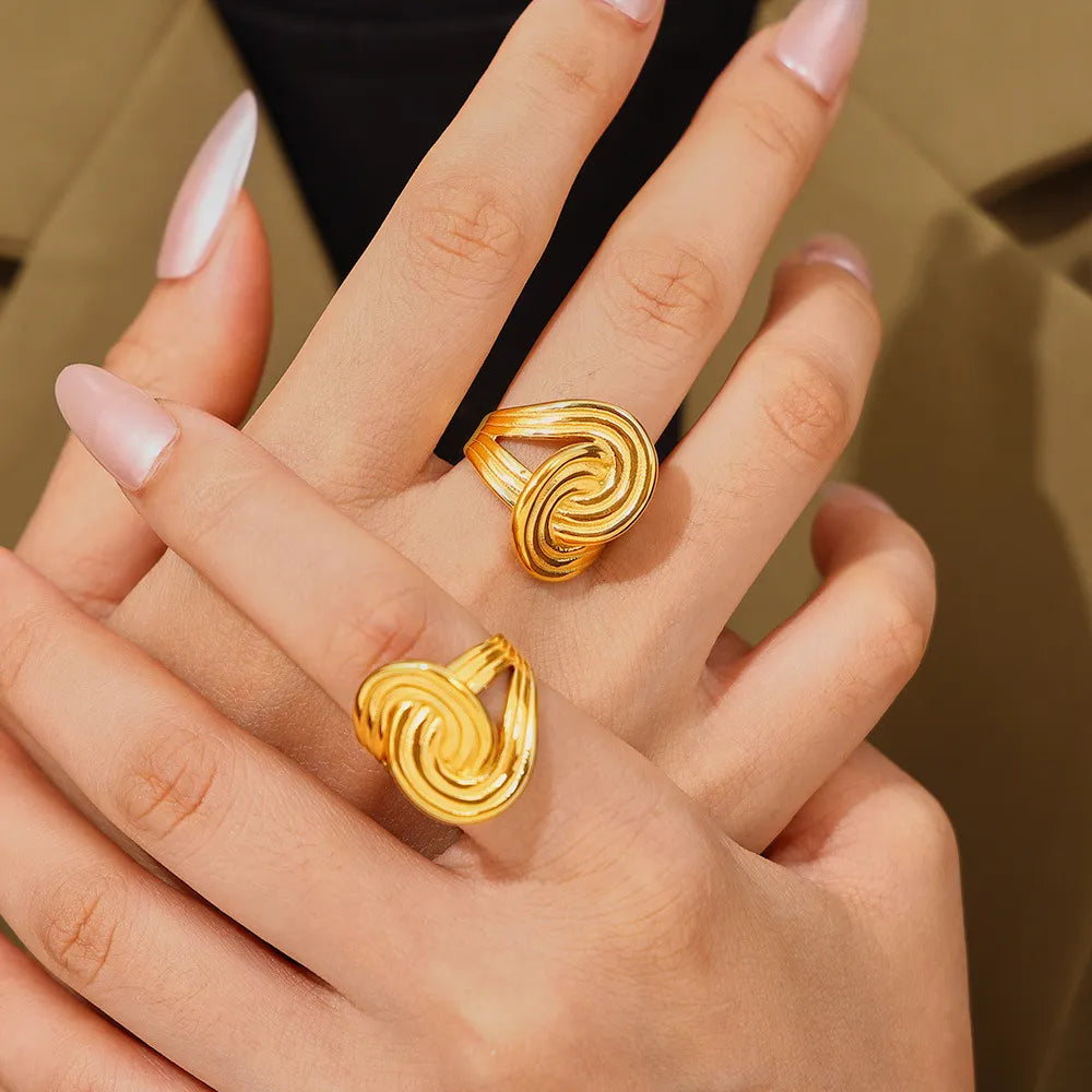 Elegant 18K gold-plated twisted ring with a smooth, shiny finish, showcasing a stylish design perfect for any occasion.