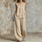 Women's sleeveless two-piece set from FitiqueFit featuring solid color wide-leg pants and matching sleeveless top, laid flat.