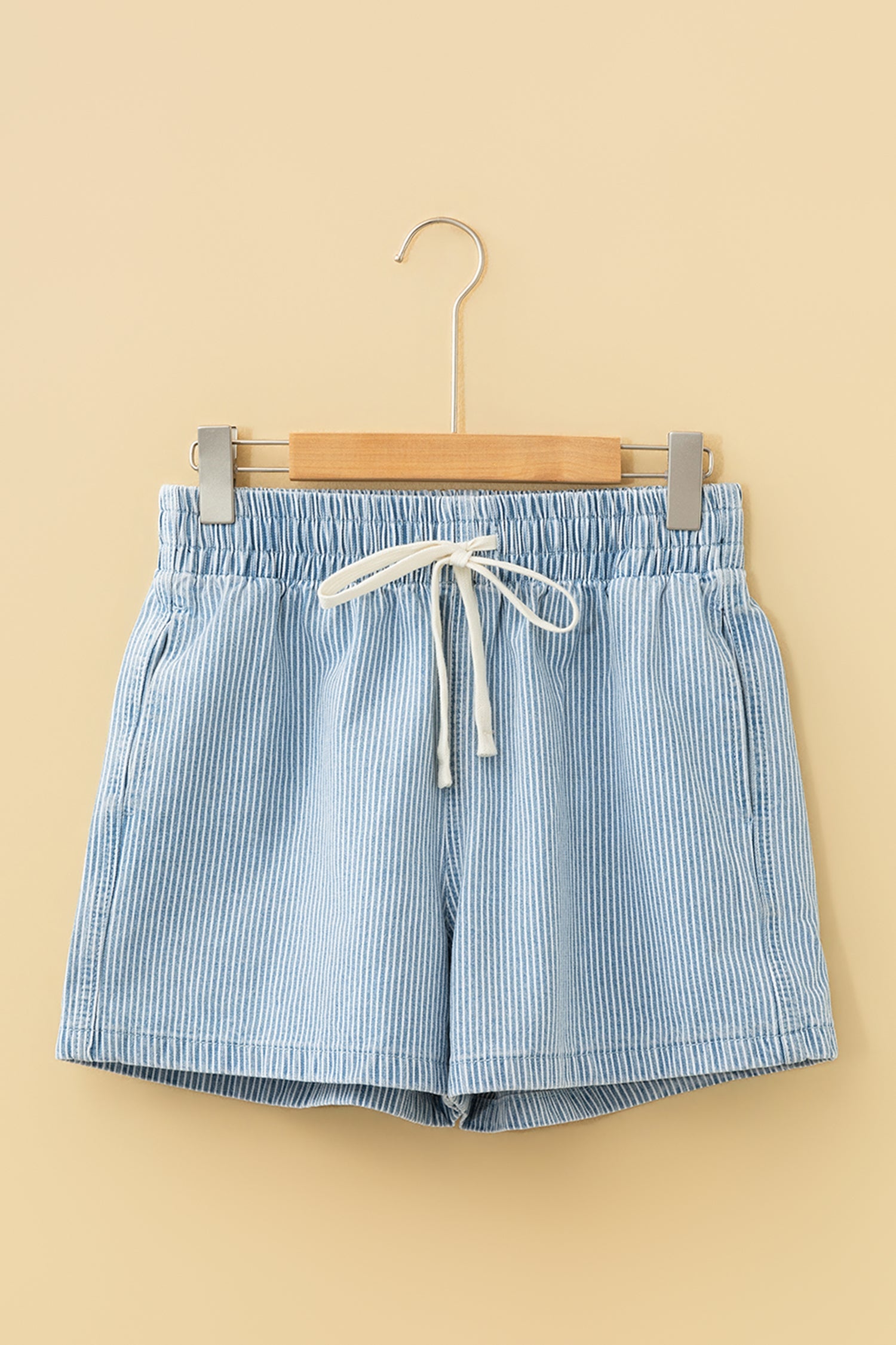 Honey-colored elastic waist denim shorts by Threaded Pear with casual fit, shown with rolled cuffs and front pockets.