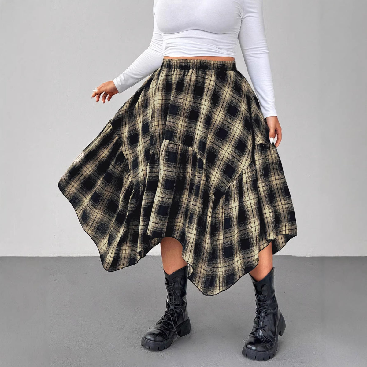 Black and beige plaid skirt with an asymmetrical handkerchief hem, gathered waist, and tiered design.