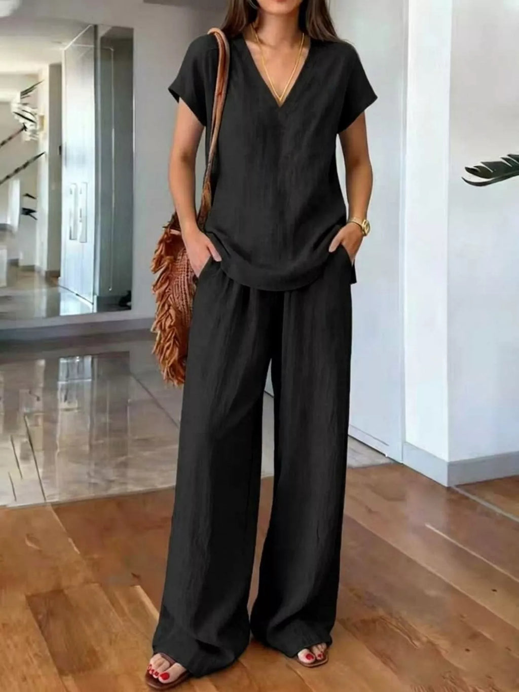 Plus size V-neck short sleeve loungewear set with matching pants by Trendsi, comfortable and stylish for relaxed wear.