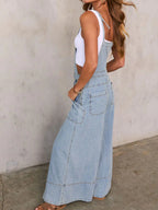 Women's relaxed fit wide leg denim overalls made from comfortable cotton blend jumpsuit, featuring straps and front pockets.