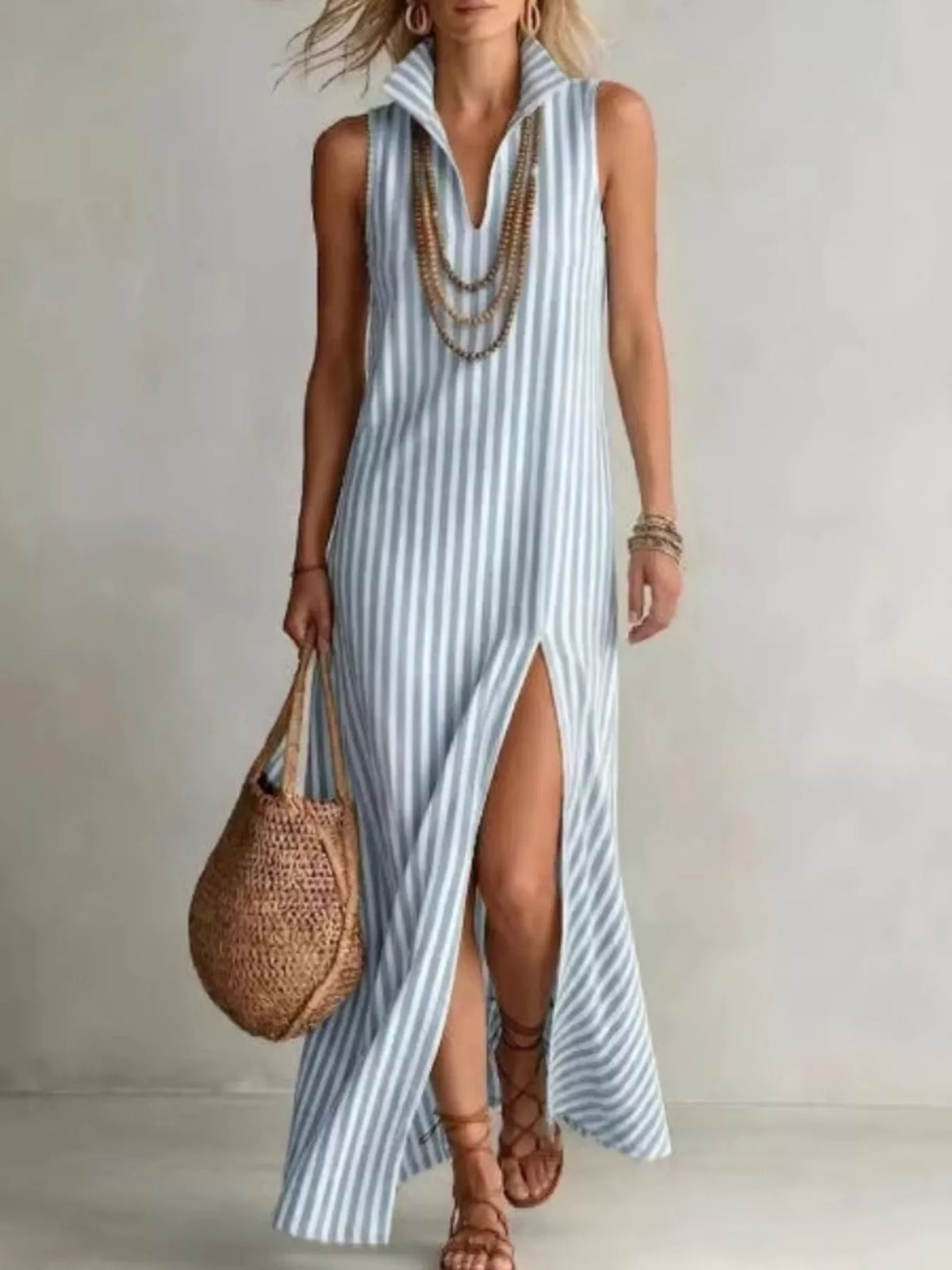 Plus size striped maxi dress with high slit by Trendsi, featuring flowing fabric and bold vertical stripes for a stylish look.