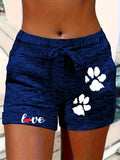 Women's printed elastic waist cropped shorts with pockets, casualwear by Plush Fashion Hub, featuring vibrant patterns and comfortable fit.