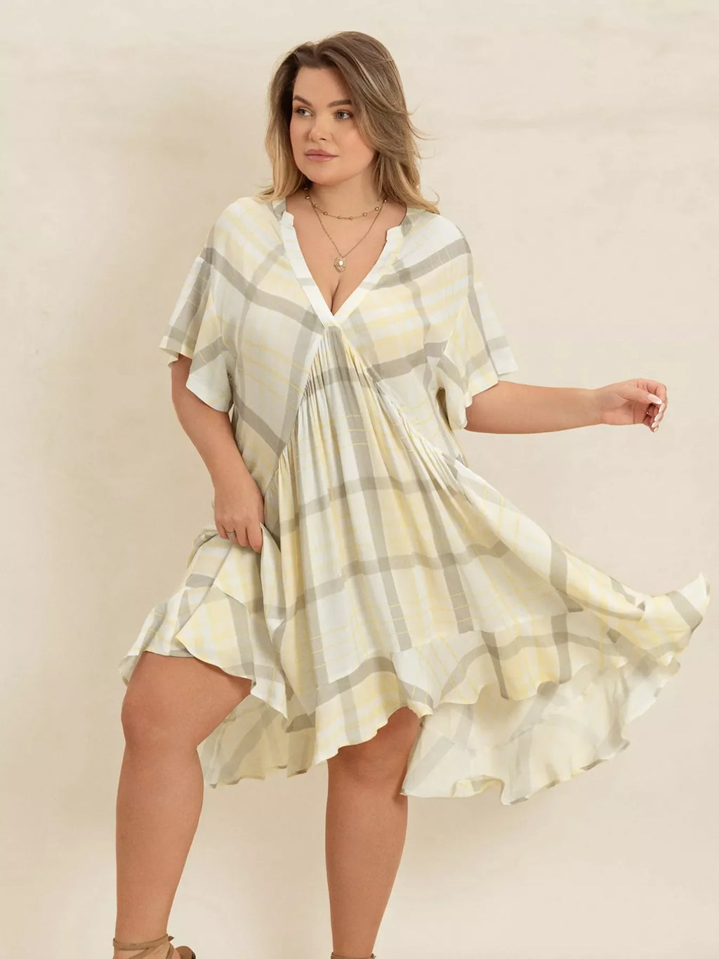 Plus size plaid flutter sleeve dress by Shopimist, featuring a stylish plaid pattern and flowing flutter sleeves.