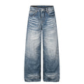 High-rise, wide-leg denim jeans in a medium-blue wash with a light faded gradient, featuring a button-fly closure.