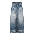 High-rise, wide-leg denim jeans in a medium-blue wash with a light faded gradient, featuring a button-fly closure.
