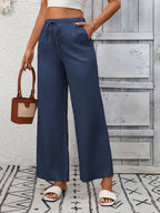 Women's high-waisted wide-leg drawstring pants in soft breathable viscose, showing relaxed fit and stylish design.