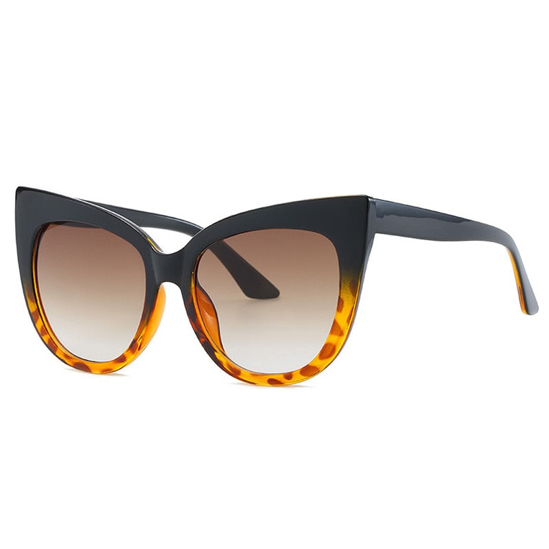 Women's oversized cat eye sunglasses with UV400 protection by Plush Fashion Hub, featuring black frames and dark tinted lenses.