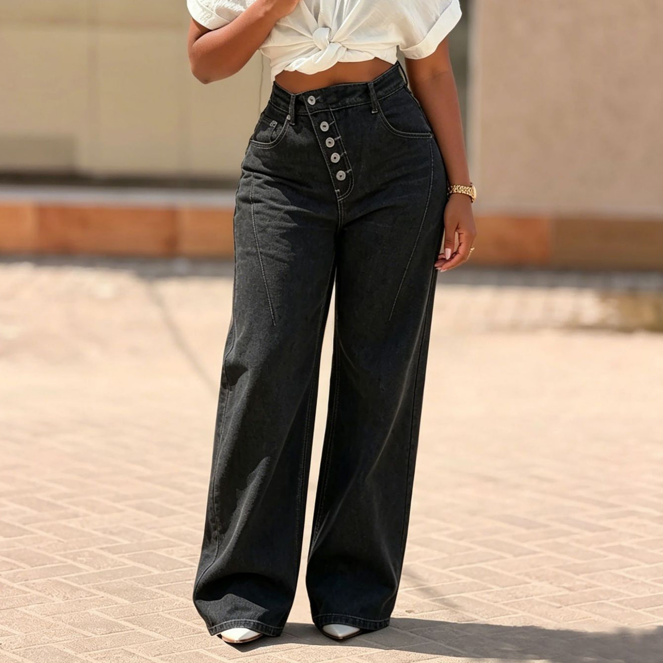 Women's black denim jeans with multi-button fly and straight leg fit, by eprolo, displayed on a plain background.