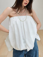 Women's strapless bubble hem tube top by Plush Fashion Hub, showing a sleek, minimalist crop top with a fitted silhouette and stylish design.