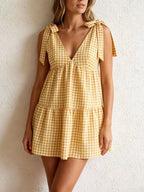 Gingham tie-shoulder mini dress by Plush Fashion Hub featuring a skirt with a stylish, feminine design and shoulder tie details.