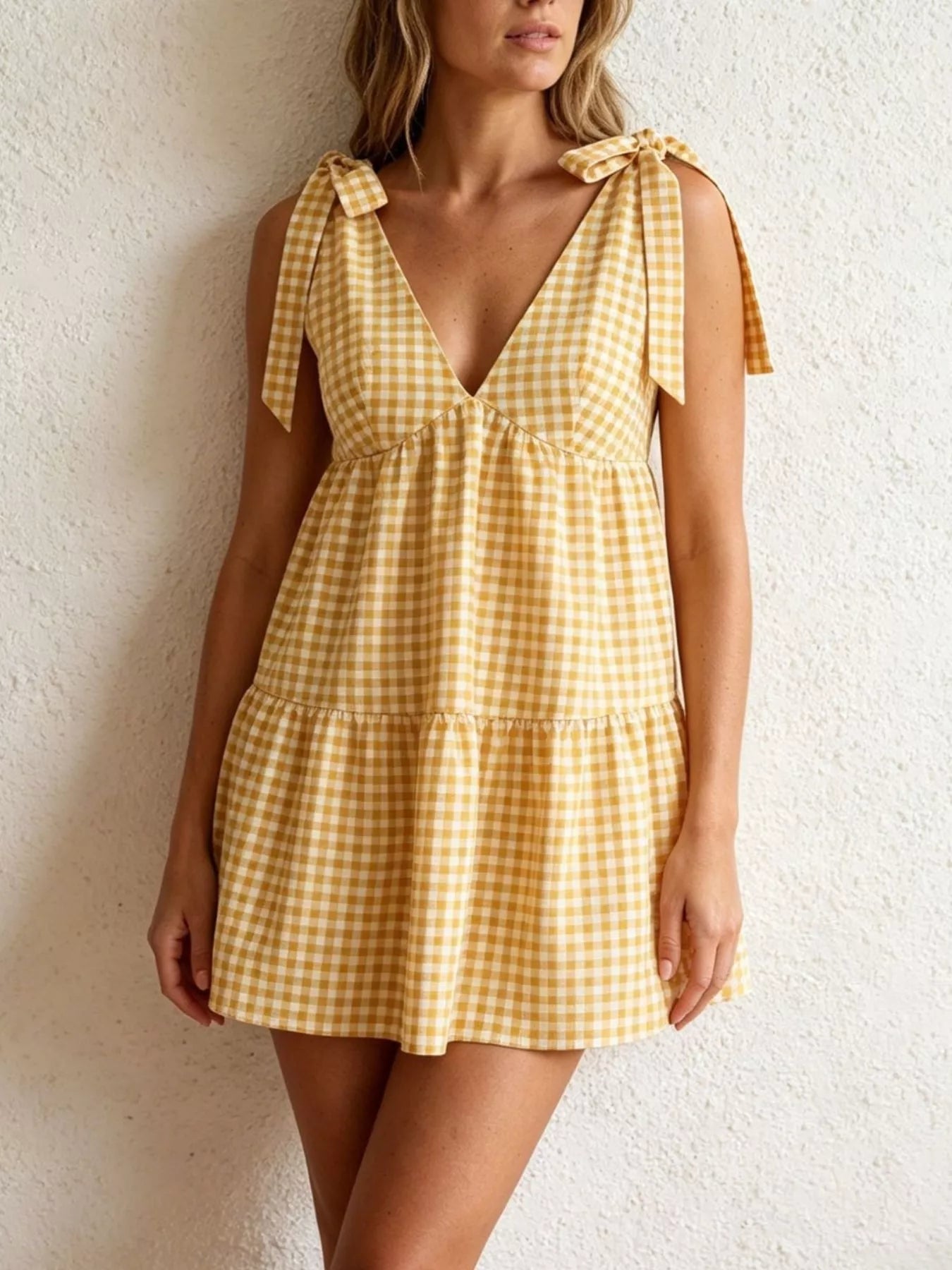 Gingham tie-shoulder mini dress by Plush Fashion Hub featuring a skirt with a stylish, feminine design and shoulder tie details.