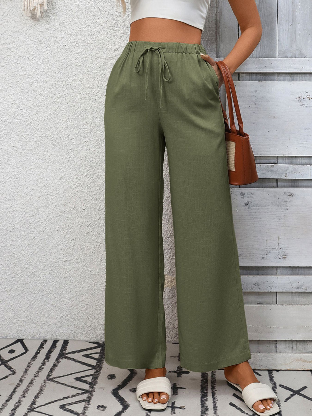 Women's high-waisted wide-leg drawstring pants in soft breathable viscose, shown with relaxed fit and comfortable waistband.