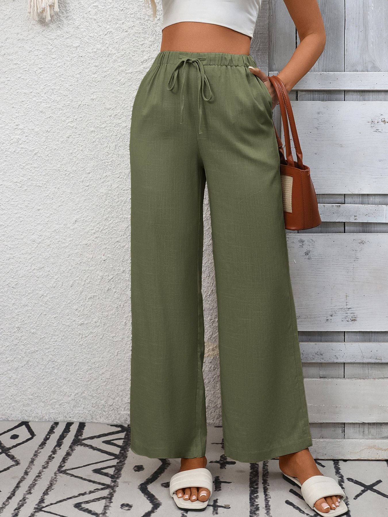Women's high-waisted wide-leg drawstring pants in soft breathable viscose, shown with relaxed fit and comfortable waistband.