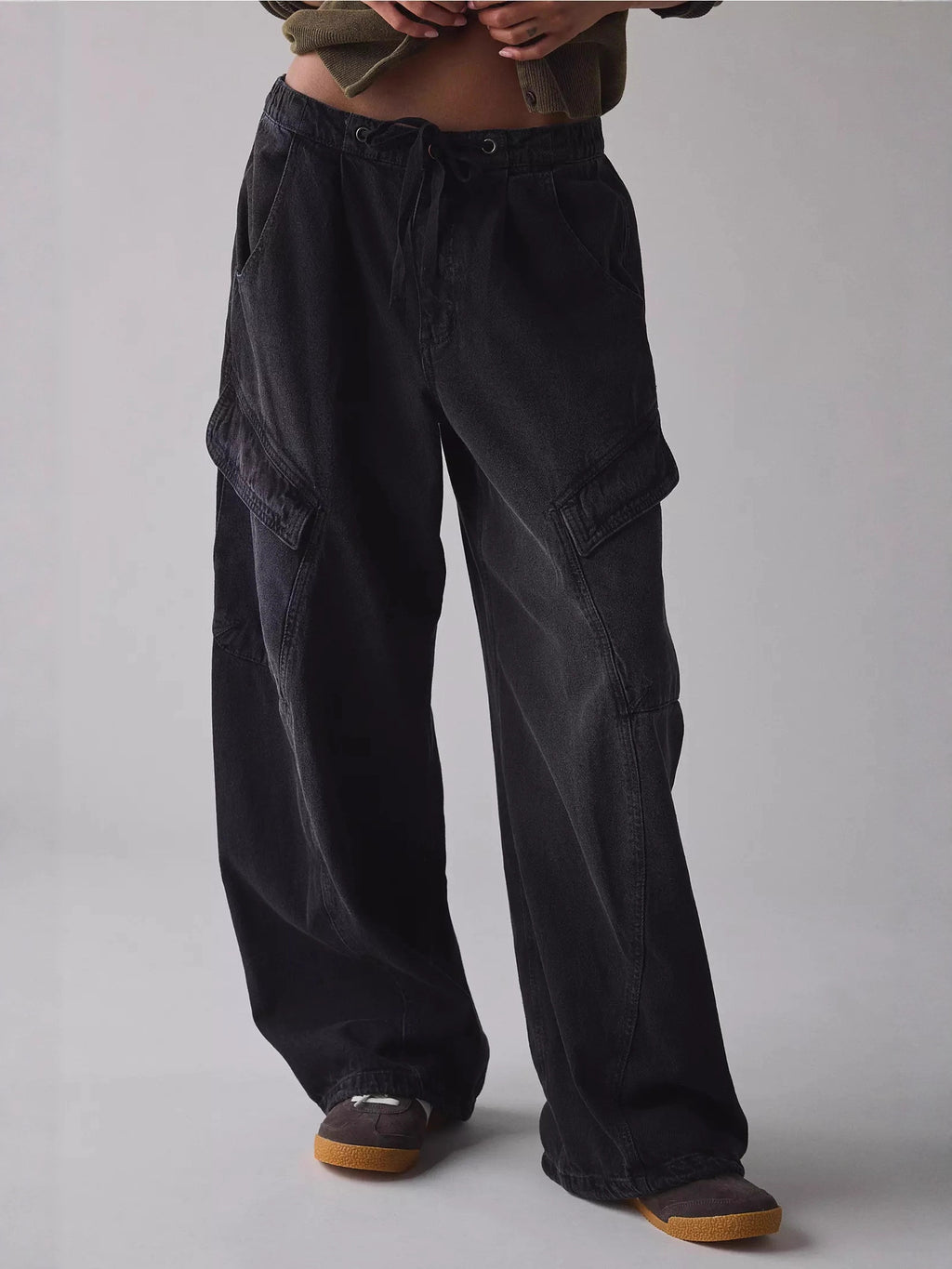 Women's drawstring waist cargo denim jeans with relaxed fit and utility style, featuring multiple pockets and casual design.