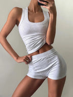 Ribbed tank top and shorts activewear set in neutral tones, designed for comfortable workout or casual wear.