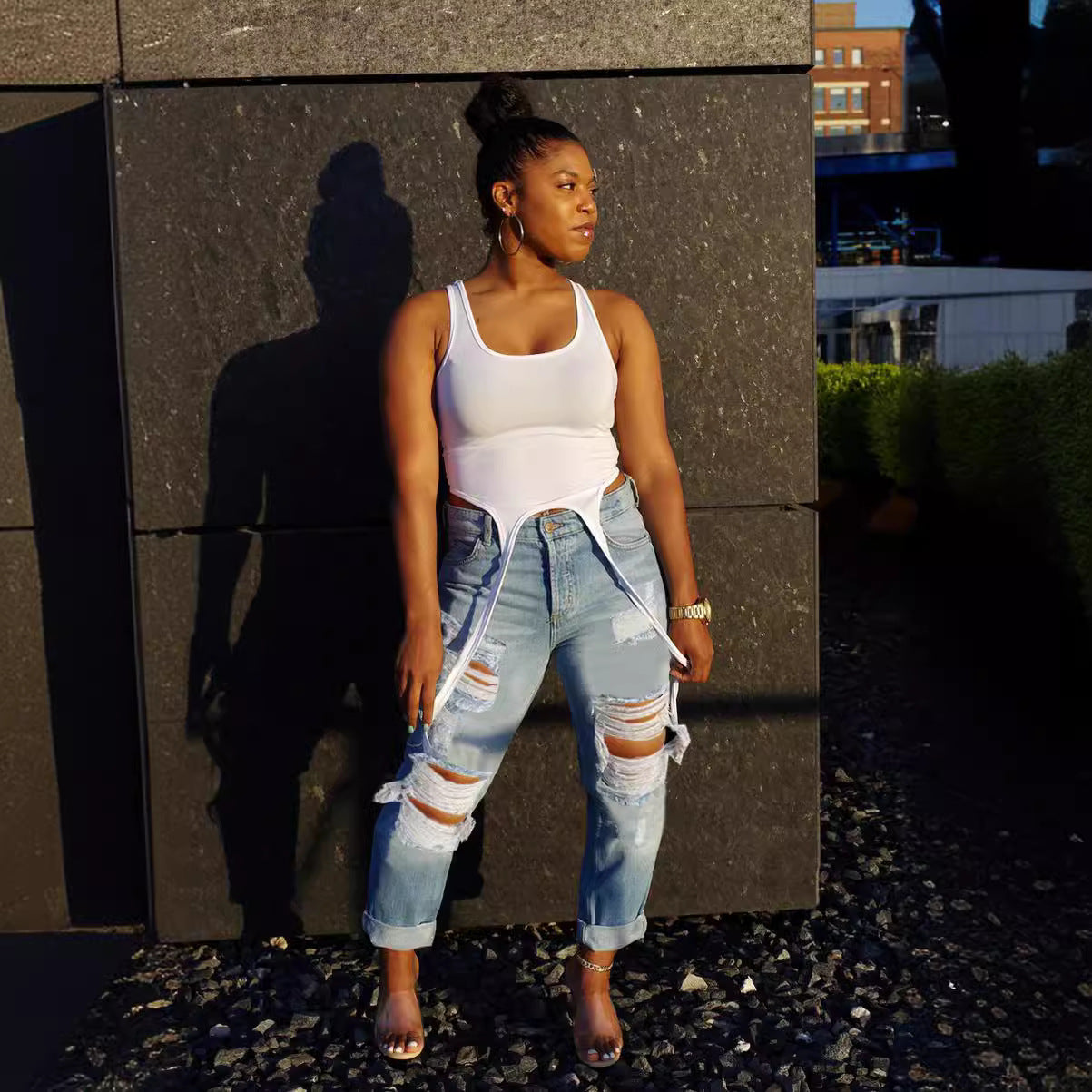 High-waisted ripped nine-panel jeans from Plush Fashion Hub, featuring a modern streetwear style with distressed details.