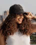 Black waterproof satin-lined dad hat with adjustable strap, featuring a classic baseball cap style from Plush Fashion Hub.