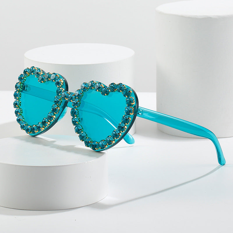 Peach heart-shaped rhinestone sunglasses with Y2K style, trendy eyewear from Plush Fashion Hub featuring sparkling embellishments.