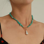 Turquoise irregular pearl necklace with varying sized pearls, stylish jewelry piece by Shopimist, close-up view of the necklace.