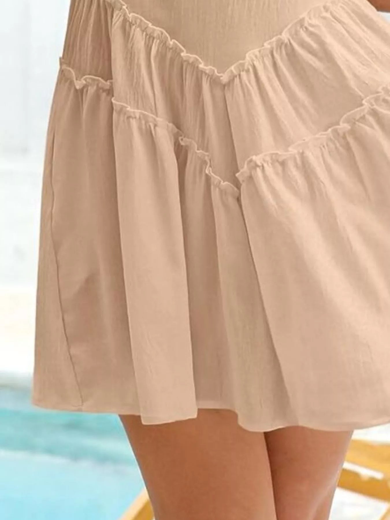 Women's sleeveless round neck mini dress with pockets, trendy casual dress by Trendsi, shown on a model in a bright setting.