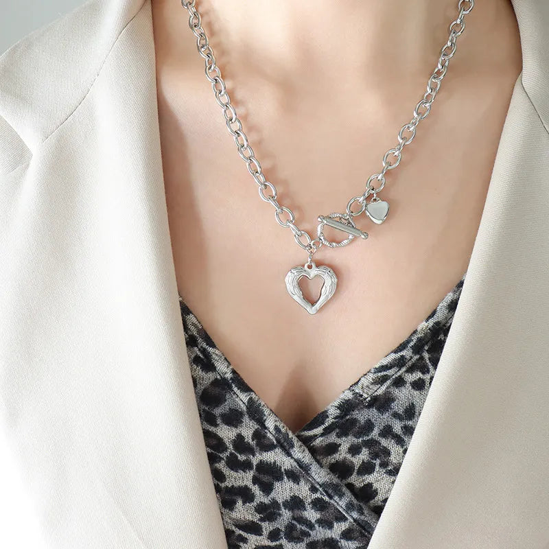 Titanium steel heart pendant necklace with a sleek design, featuring a shiny silver finish and a delicate chain.