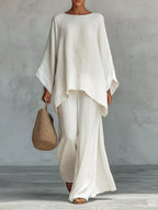 Plus size full size round neck top and wide leg pants set by Trendsi, featuring a comfortable, stylish matching pant set.