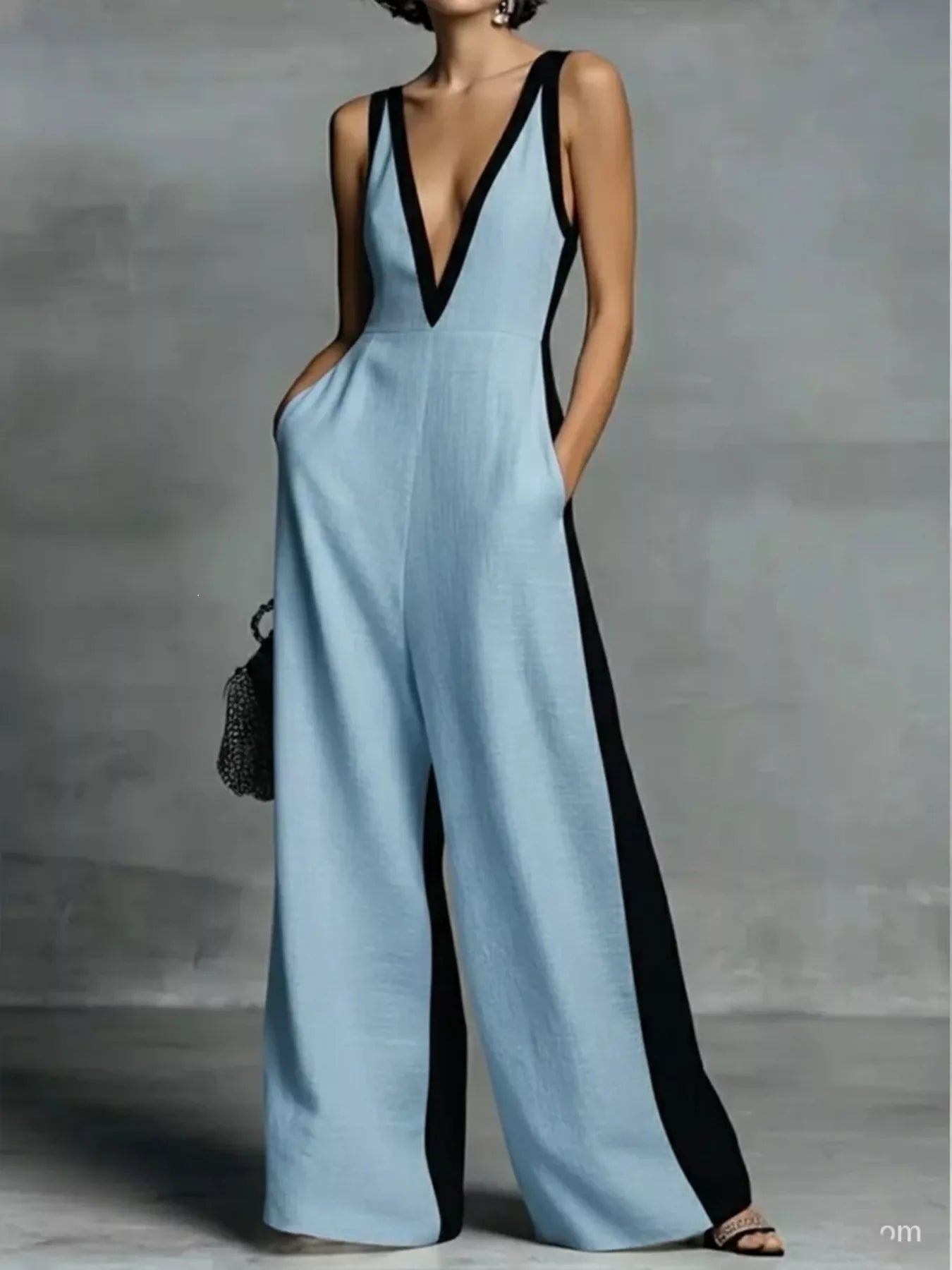 Deep V-neck wide-leg jumpsuit by Trendsi, stylish onesie with flowing fabric and a flattering V-neck neckline.